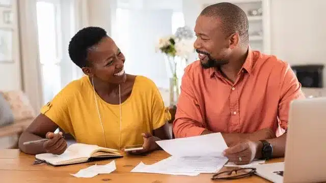 Family reviewing their monthly budget to start saving my family money