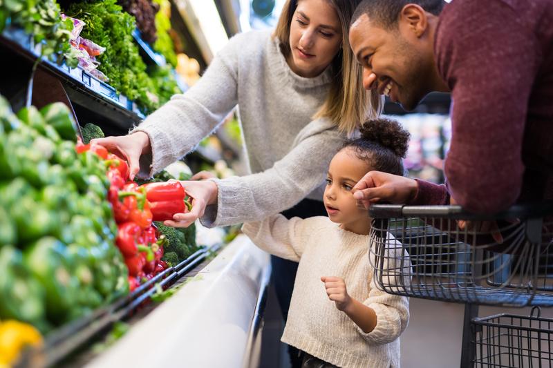 Family enjoying a budget-friendly grocery shopping trip when you spend or use money wisely